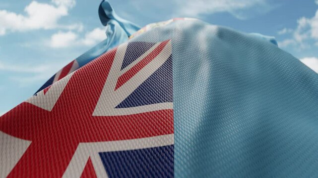 Wavy flag of Fiji blowing in the wind in slow motion. Waving colorful Fijian flag team symbol abstract vertical background. Blue sky with clouds. World countries flying flags concept