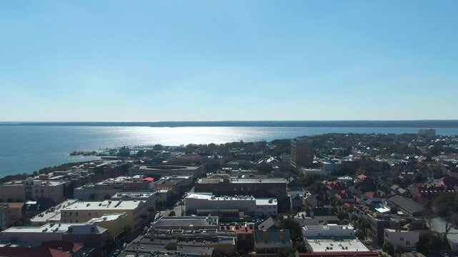 Endless ocean and cityscape of Charleston bellow, aerial ascend view