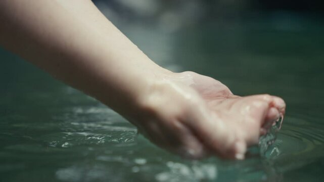 Young woman enjoying a tropical rainforest waterfall in the jungle 