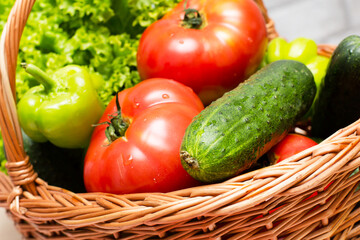 Fresh vegetables in basket. Tomato, cucumber, pepper and lettuce