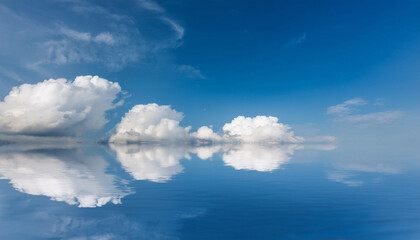 Blue Sky and Clouds Reflecting in Water and Copy Space