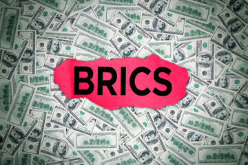 A dedollarisation concept with the BRICS on top of a pile of US dollar bills