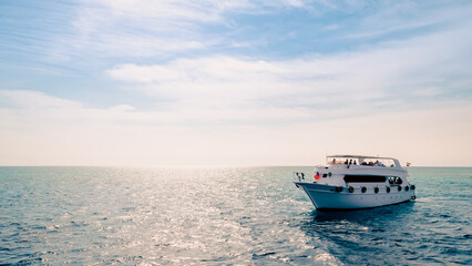 tourist boat in the Red Sea on a background of blue sky and clouds
