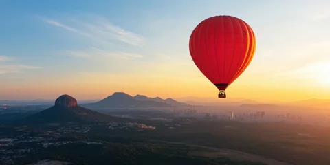 A beautiful sunrise landscape with a red hot air balloon in sky