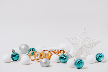 Christmas Product Presentation Display made with Sleigh Podium and Festive Ornaments on White Background. Minimalist Holiday Scene for Festive Marketing and Seasonal Promotions.