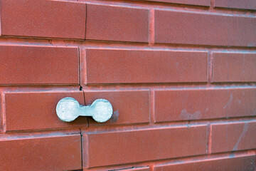 external concrete overlay applied to a cracked brick wall, representing a practical repair solution...