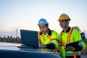 Diverse ethnicity male technicians working in the wind turbines field. 