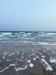 Blue waves on the beach in summer.