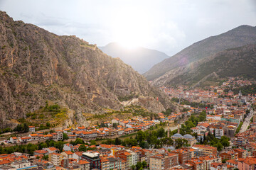 Naklejka premium Fascinating view of the city of Amasya, also known as the city of princes. wonderful clouds coming out of the mountains. YESILIRMAK river.