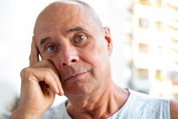 Elderly man gazing thoughtfully, reflecting on life with hint sadness, emotional and health issues, sadness in elderly, aging concerns