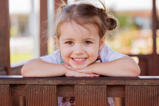 Happy preschool girl smiling in cubby house at kindergarten