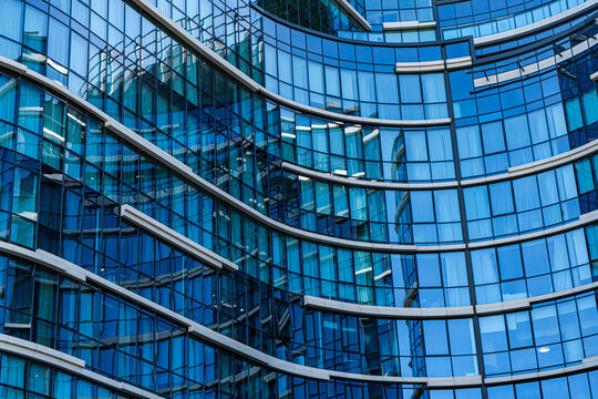 Close-up of blue glass facade in modern curved building