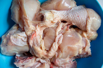 Fresh raw chicken pieces to make delicious dishes with a blue background