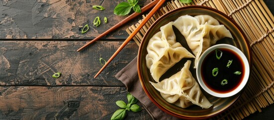 Colored dumplings in a bowl soy sauce cabbage and chopsticks on a wooden surface with space for text. with copy space image. Place for adding text or design