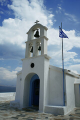Greek island white church with flag on the beach