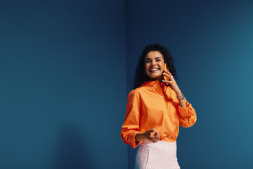 Confident female entrepreneur in vibrant, monochromatic office setting with bold color blocking