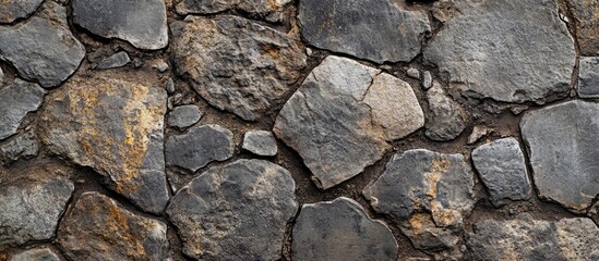 Obraz premium Uneven stone and cobblestone texture A grungy aged background for your design. with copy space image. Place for adding text or design