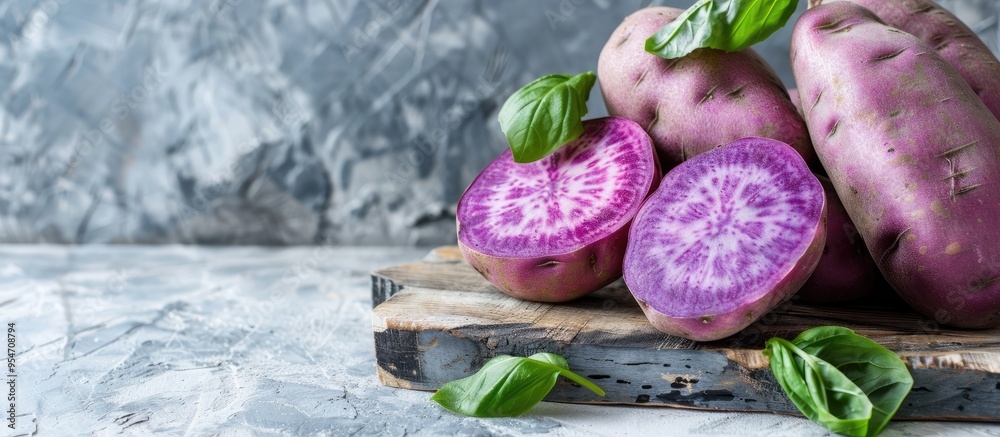 Poster fresh purple sweet potato set against a white background. with copy space image. place for adding te