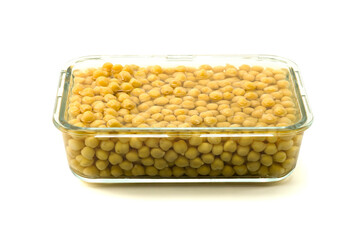 Boiled whole chickpea with water in a glass container isolated on white background with clipping path closed up stack