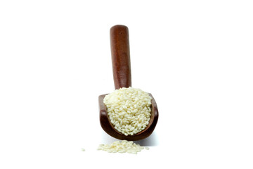 Close-up of a wooden scoop fill with white sesame seeds isolated on white background with clipping path, stack
