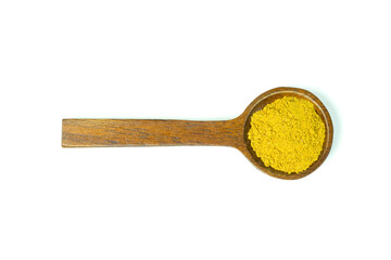 Yellow curry powder in a wooden spoon isolated on white background top view flat lay.