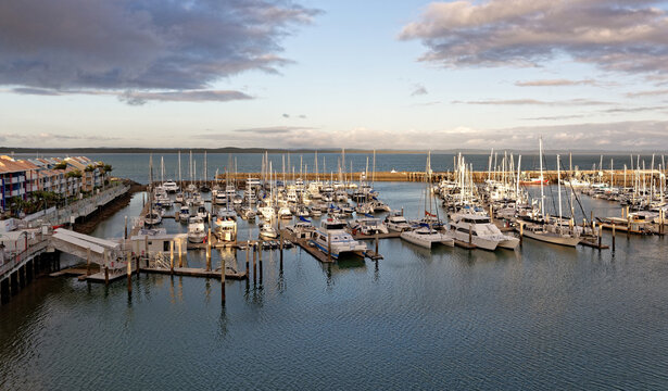 Boats anchored at sunset with dramatic clouds and dusk skyline