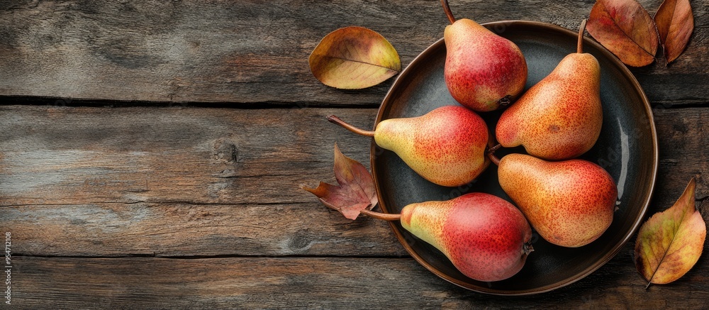 Fototapete plate with fresh pears on a wooden table. with copy space image. place for adding text or design