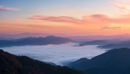 Fototapeta premium A serene, panoramic view of a misty mountain range during sunrise, with soft pastel colors and ethereal clouds.