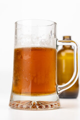 Frosty Beer Jug with Empty Bottle in Background