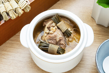 Chinese health-preserving soup - braised pork bone soup with barley and rush