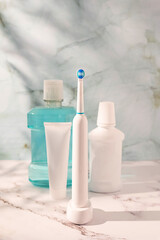 Morning oral hygiene routine, toothbrush,electric toothbrush, floss, toothpaste tube and mouthwash.