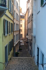 Fototapeta premium Narrow street alley and old architecture in a European city, no people