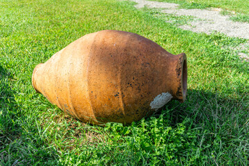 Small Kvevri Qvevri Churi on the grass - earthenware clay vessel used for the fermentation, storage and ageing of traditional Georgian wine.