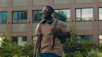 African American happy success winner student guy university education learning college test exam good result man ethnic male in city outdoors win victory studying achieve achievement rejoice champion
