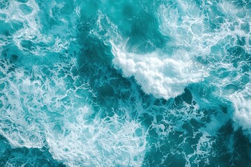Aerial view of rough ocean waves creating dynamic pattern of blue water and white foam. Top shot of ocean texture perfect for backgrounds, nature themes and environmental content