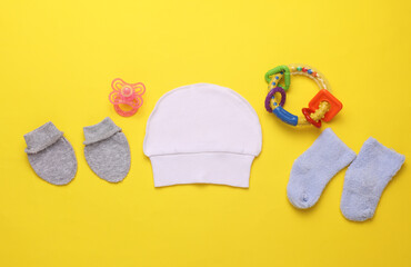 Accessories for newborn on yellow background. Top view