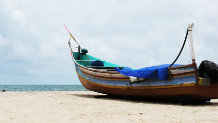 Fototapeta premium A fishing boat moored at Marari beach, Alappuzha, Kerala, India
