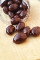 Some Almonds covered with dark chocolate close up view.