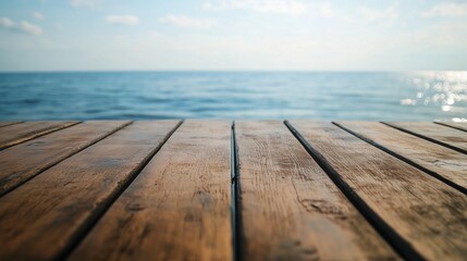 Fototapeta premium Closeup shot of a wooden table with sea in the background.