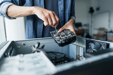 Computer repair technician repairing and testing on Pc.