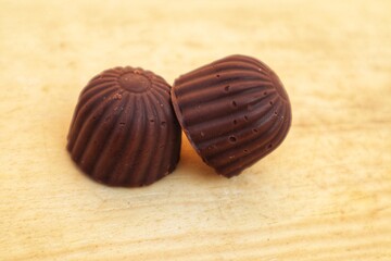 Sweet chocolate candy on wooden background.