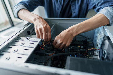 Computer repair technician repairing and testing on Pc.