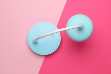 Desktop wireless flexible LED lamp on a pink background. Top view