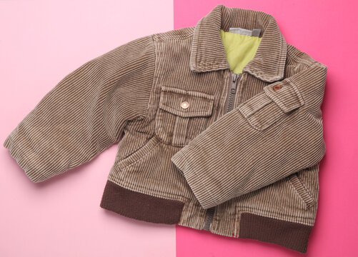 Children's corduroy jacket on pink background. Top view
