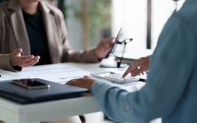 Business administrator calculates profit in a conference room