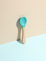 Eco baby spoon on pastel background