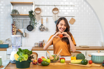 Portrait of beauty health asian woman having fun hold tomato cooking, vegan food healthy eat, fresh vegetable, Lycopene, vitamins, skincare, vegetarian in kitchen.Diet.Fitness, healthy food