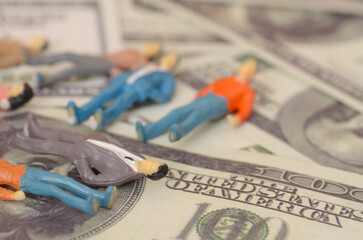 a businessman collapsing onto a pile of banknotes starkly illustrates the peril of financial mismanagement and the overwhelming stress that can accompany economic failure.