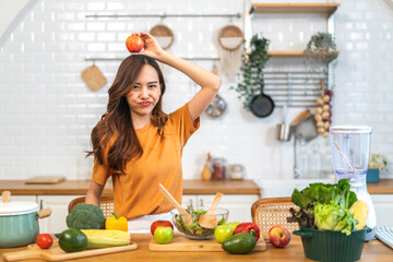 Portrait of beauty body slim healthy asian woman big smile cooking and preparing vegan food healthy holding apple, green apple, dental, teeth, fruit in kitchen at home.Diet.Fitness, healthy food