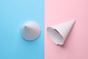 Birthday cones hats on blue pink background